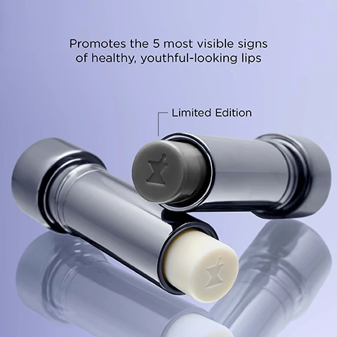 Image 1 - Two shiny metallic tubes, one capped in grey and one open showing a cream product, both embossed with a logo, are displayed with the text Promotes the 5 most visible signs of healthy, youthful-looking lips and Limited Edition. Image 2 - A dark gray lipstick tube with a textured, crumbly substance and a mortar and pestle symbol on its cap is shown next to a shimmery pink swatch, with the text With innovative pH-adjusting technology, this formula instantly adapts to your skin to mimic the hue of your lip vermilion.